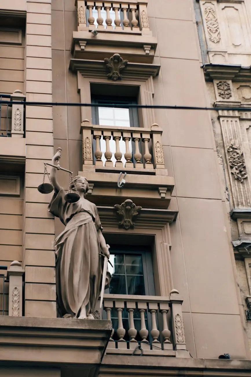 Statue of Lady Justice on an ornate historic building facade.